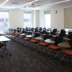 A view from the side of the classroom showing individual desks on wheels.