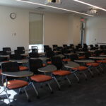 A view of the type of seating in the room with individual chair-tables.
