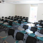 A view of the back of the classroom showing the individual chair-tables for furniture.