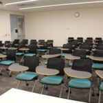 A view of the back of the classroom showing flexible student desks for seating.