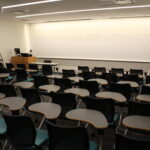 A view of the front of the classroom showing the podium and whiteboard.