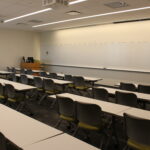 A view of the front of the classroom showing the podium and whiteboard.