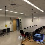 Image of the classroom looking back towards the seating in the room. All flexible tables and chairs, arranged in one large table.