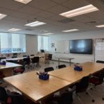 A view of the classroom showing the front of the room with one large TV display.