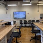 Image of the side of the classroom showing off a single TV display used as a collaboration space.