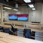 Image from the back of the classroom showing student work benches.