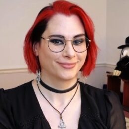 woman with red hair and glasses