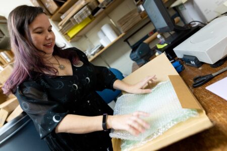 Interlibrary Loan staff packaging an item for delivery