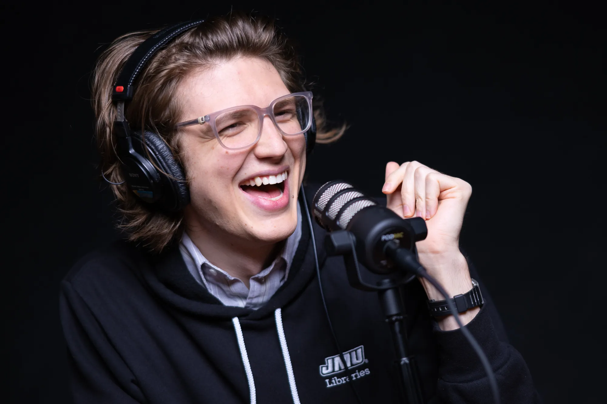 A person wearing headphones talks into a microphone