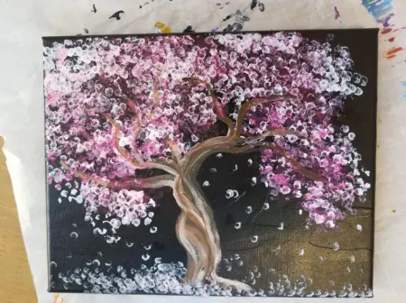 A mixed media painting of a tree blooming with pink flowers