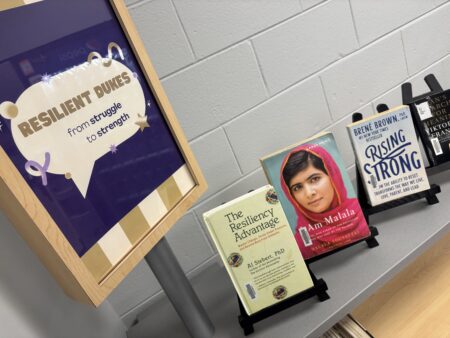 the "resilient dukes: from struggle to strength" in JMU Libraries Express; the photo includes the display sign and a few of the books on display.