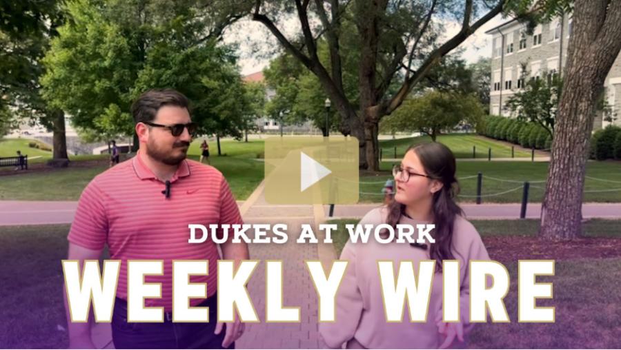 screenshot from the video showing two employees walking to the library