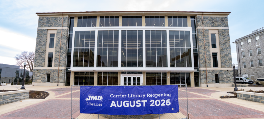 Carrier Library's Stan and Rosemary Jones Wing at JMU with a big sign in front of it that says "Carrier Library Reopening August 2026"