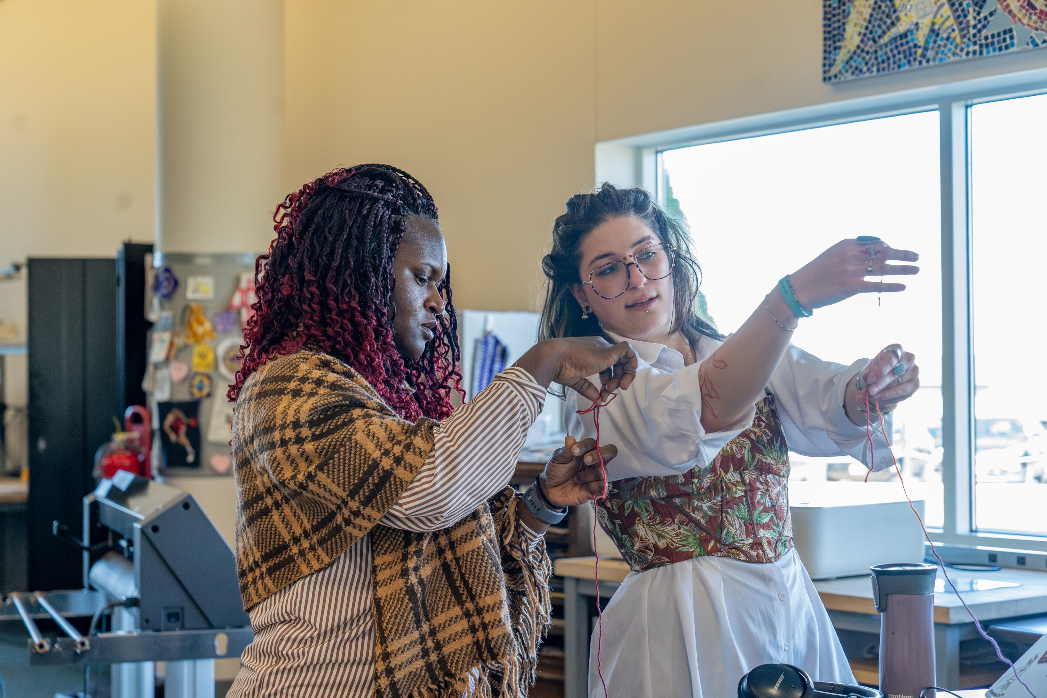 two people learning crochet in a makerspace