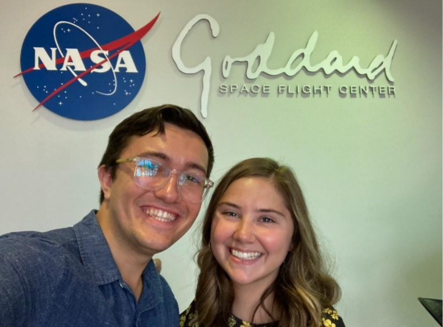 Cameron and Jess in front of a sign at NASA