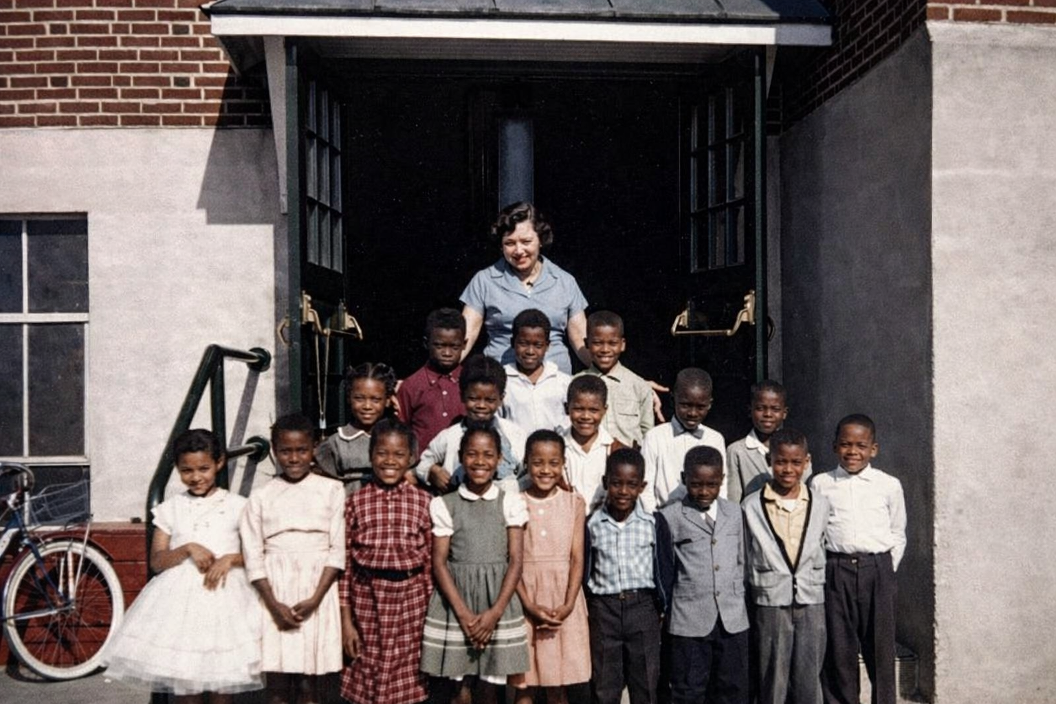 Mary Awkard Fairfax and students standing in front of Lucy F. Simms School