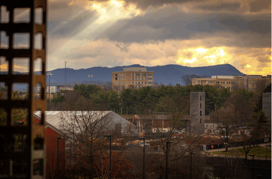 view of rose library and massanutten peak with sun peeking through clouds