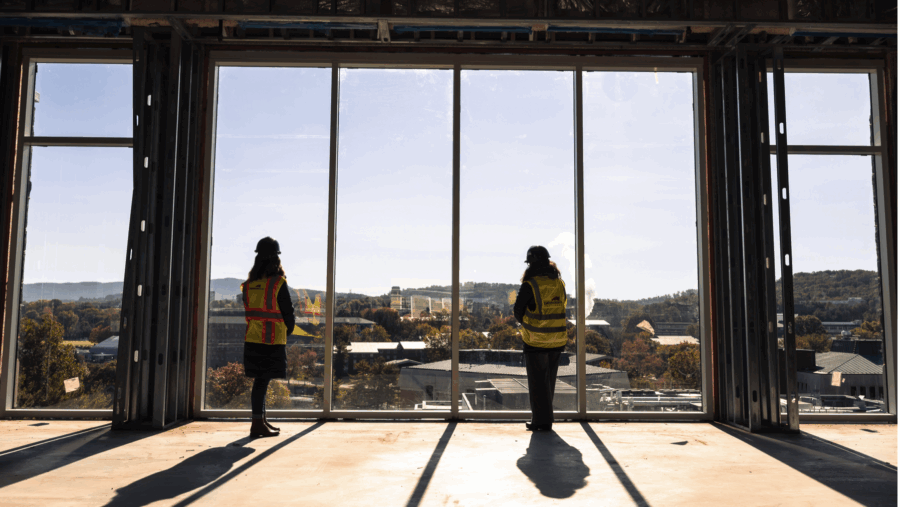 two people look out carrier's large windows at the shenandoah valley