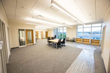 Large open space with a meeting table and view of the mountains. 