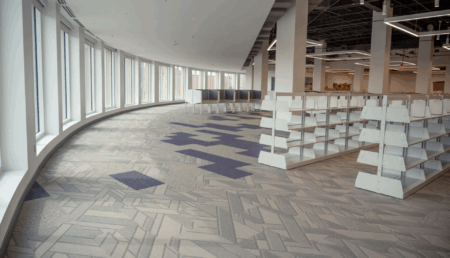 a photo inside carrier library showing big windows and empty shelves. the photo is by a breeze photographer