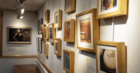 framed artwork on the wall in the little gallery undergrounds in JMU's music library