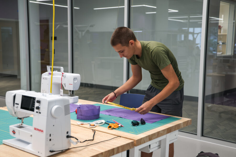 a person using a sewing machine