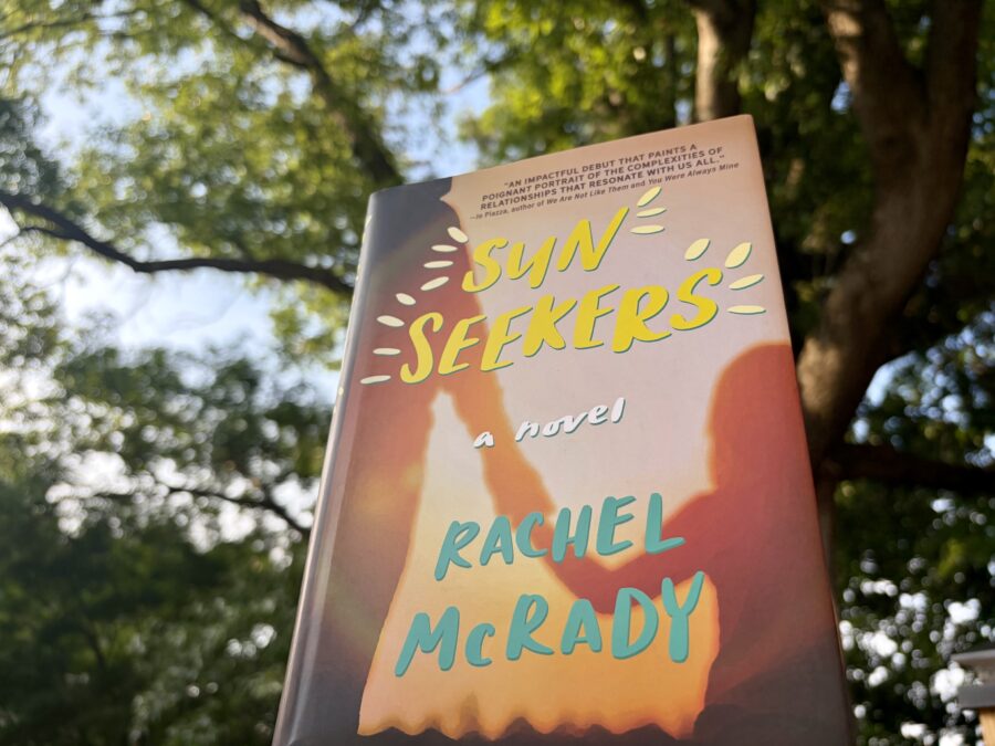 photo of the sun seekers book with a tree lit by evening sun in the background
