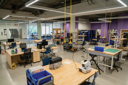 Large room with desks, work benches, toolboxes, and various Makery equipment.