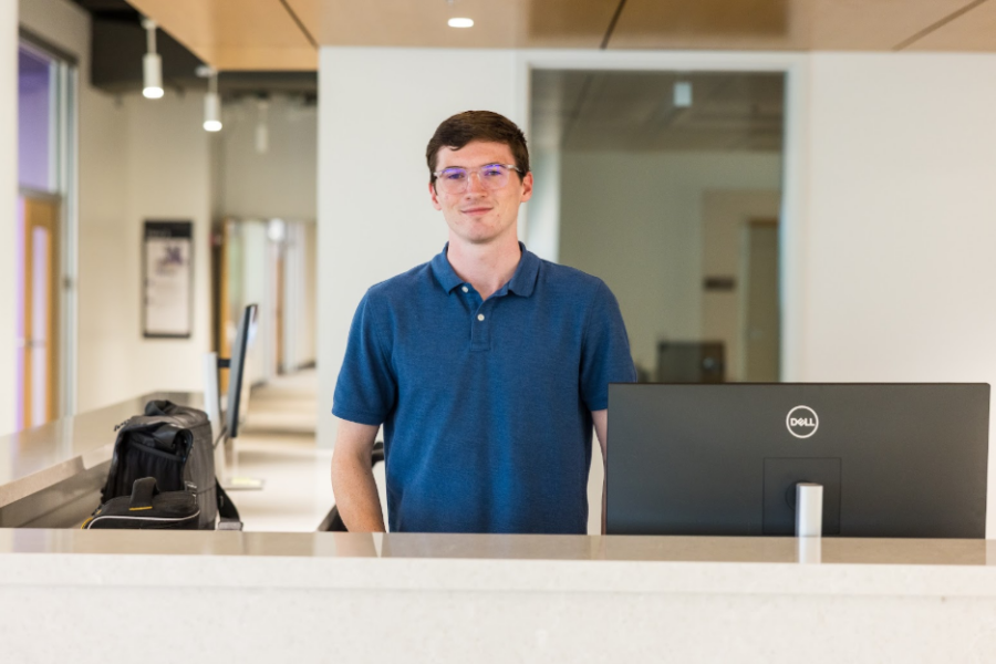 man standing behind a desk