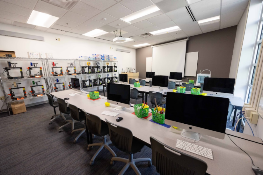 classroom full of 3D printers and Mac computers
